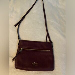 Never carried Kate Spade crossbody in burgundy pebbled leather.